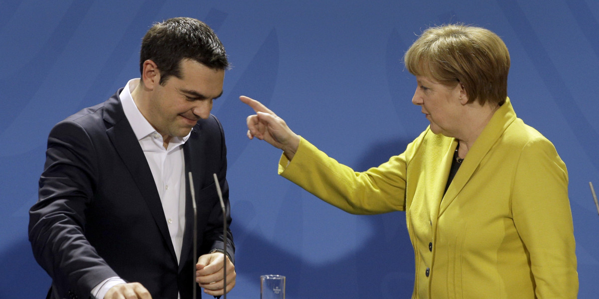 German Chancellor Angela Merkel, right, points as she and the Prime Minister of Greece Alexis Tsipras leave after a press conference as part of a meeting at the chancellery in Berlin, Germany, Monday, March 23, 2015. (AP Photo/Michael Sohn)