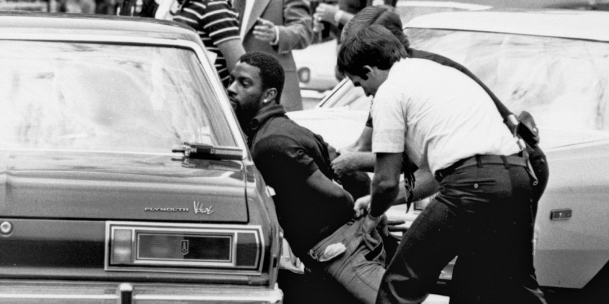 FILE - In this May 18, 1979 file photo, police handcuff a suspect during a drug raid in Miami. Police said eight were arrested and marijuana was seized. On the occasion of  “Legalization Day,” Thursday, Dec. 6, 2012, when Washington’s new law takes effect, AP takes a look back at the cultural and legal status of the “evil weed” in American history. (AP Photo/Al Diaz, File)