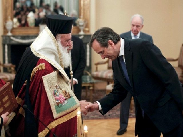 Newly appointed Greek Prime Minister Samaras bows in front of Greece’s Orthodox Archbishop Ieronymos after a swearing in ceremony at the Presidential palace in Athens