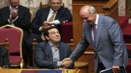 Greek Prime Minister Alexis Tsipras shakes hands with leader of main opposition New Democracy conservative party Evangelos Meimarakis after delivering his speech during a parliamentary session in Athens