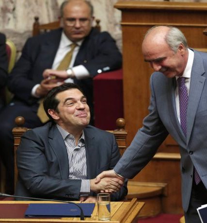 Greek Prime Minister Alexis Tsipras shakes hands with leader of main opposition New Democracy conservative party Evangelos Meimarakis after delivering his speech during a parliamentary session in Athens