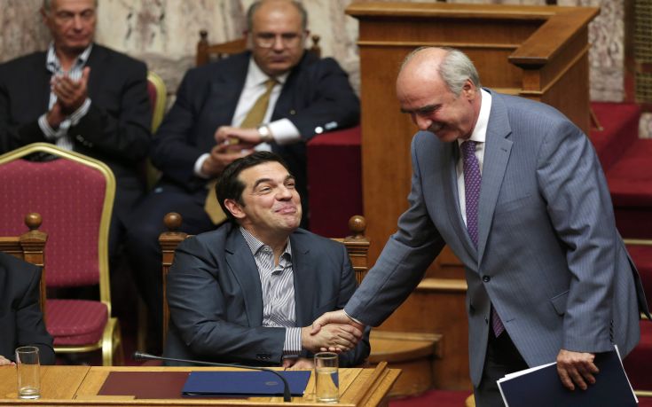 Greek Prime Minister Alexis Tsipras shakes hands with leader of main opposition New Democracy conservative party Evangelos Meimarakis after delivering his speech during a parliamentary session in Athens