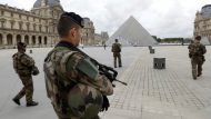 FILE PHOTO – French army soldiers patrol near the Louvre Museum Pyramid’s main entrance in Paris