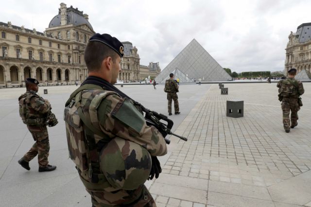 FILE PHOTO – French army soldiers patrol near the Louvre Museum Pyramid’s main entrance in Paris