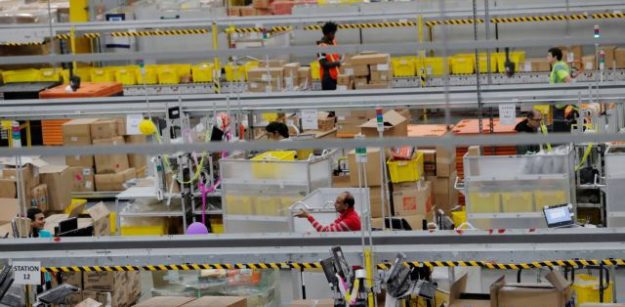 FILE PHOTO: FILE PHOTO: Amazon workers perform their jobs inside of an Amazon fulfillment center on Cyber Monday in Robbinsville, New Jersey