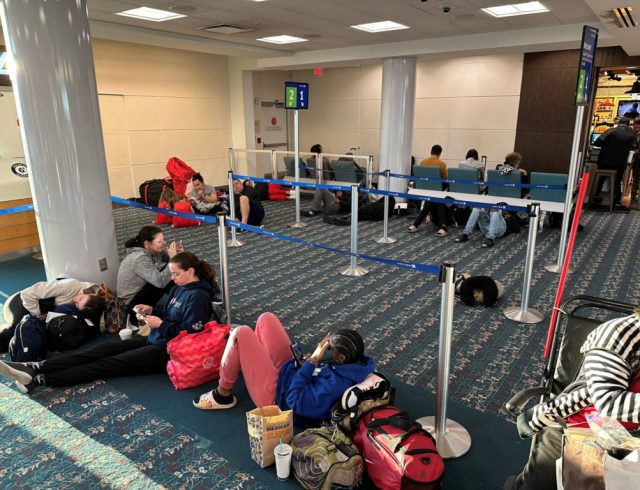 Stranded passengers wait at Orlando International Airport, as flights were grounded after FAA system outage, in Orlando