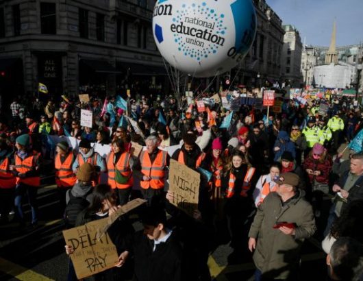 Workers take part in a strike, in London
