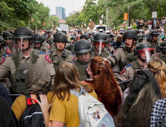 Texas state troopers in riot gear try to break up a pro-Palestinian protest at the University of Texas