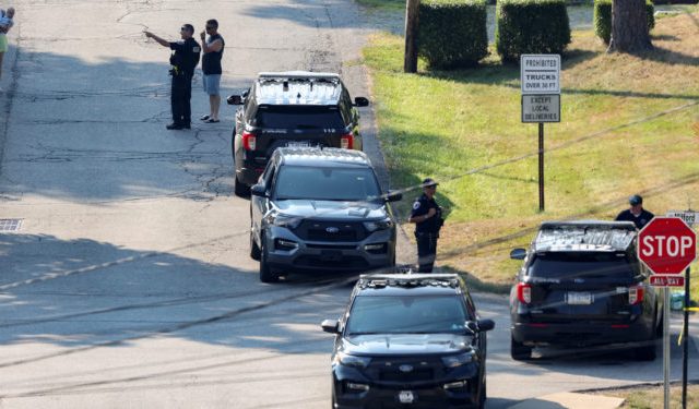 Law enforcement members guard the perimeter of the home of Trump shooting suspect, in Bethel Park