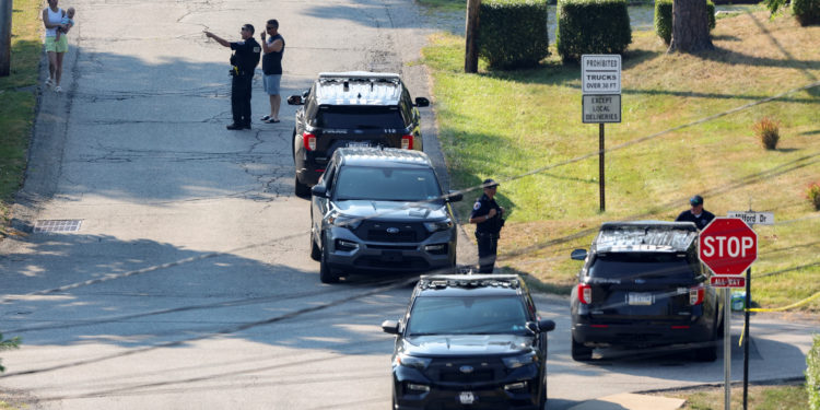 Law enforcement members guard the perimeter of the home of Trump shooting suspect, in Bethel Park