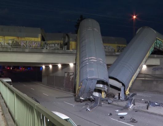 One person seriously injured after freight train partially goes over bridge