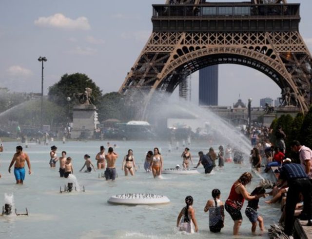 People cool off in the Trocadero fountains across from the Eiffel Tower in Paris as a heatwave hit much of the country