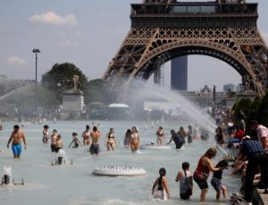 People cool off in the Trocadero fountains across from the Eiffel Tower in Paris as a heatwave hit much of the country