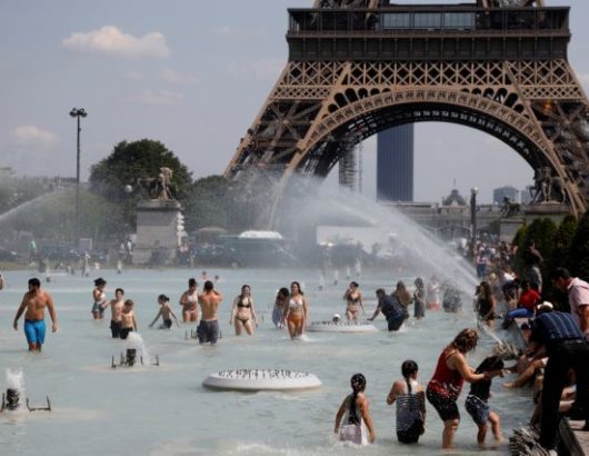 People cool off in the Trocadero fountains across from the Eiffel Tower in Paris as a heatwave hit much of the country