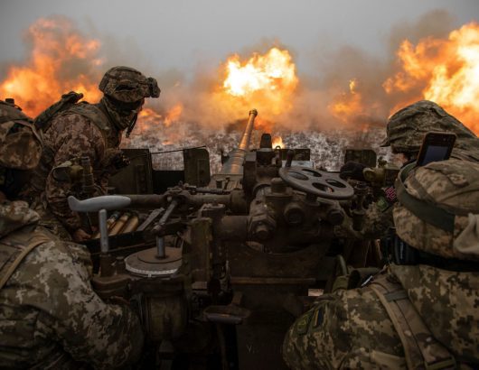 Ukrainian servicemen fire an anti-aircraft gun towards Russian positions on a frontline near the town of Bakhmut